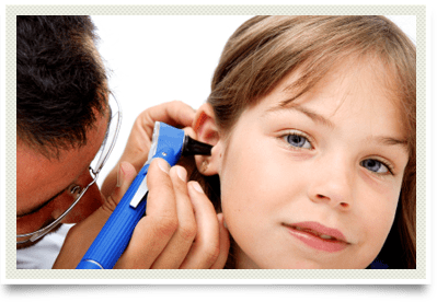 Photo of child having ears checked